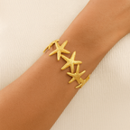 Stella – Bracelet jonc étoiles de mer doré, Manchette marine statement